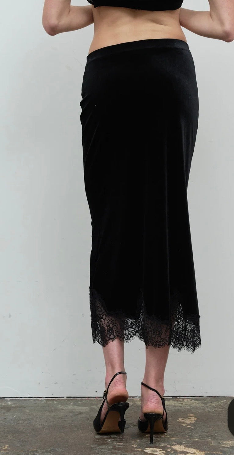 Back view of the long black skirt with a scalloped lace hem