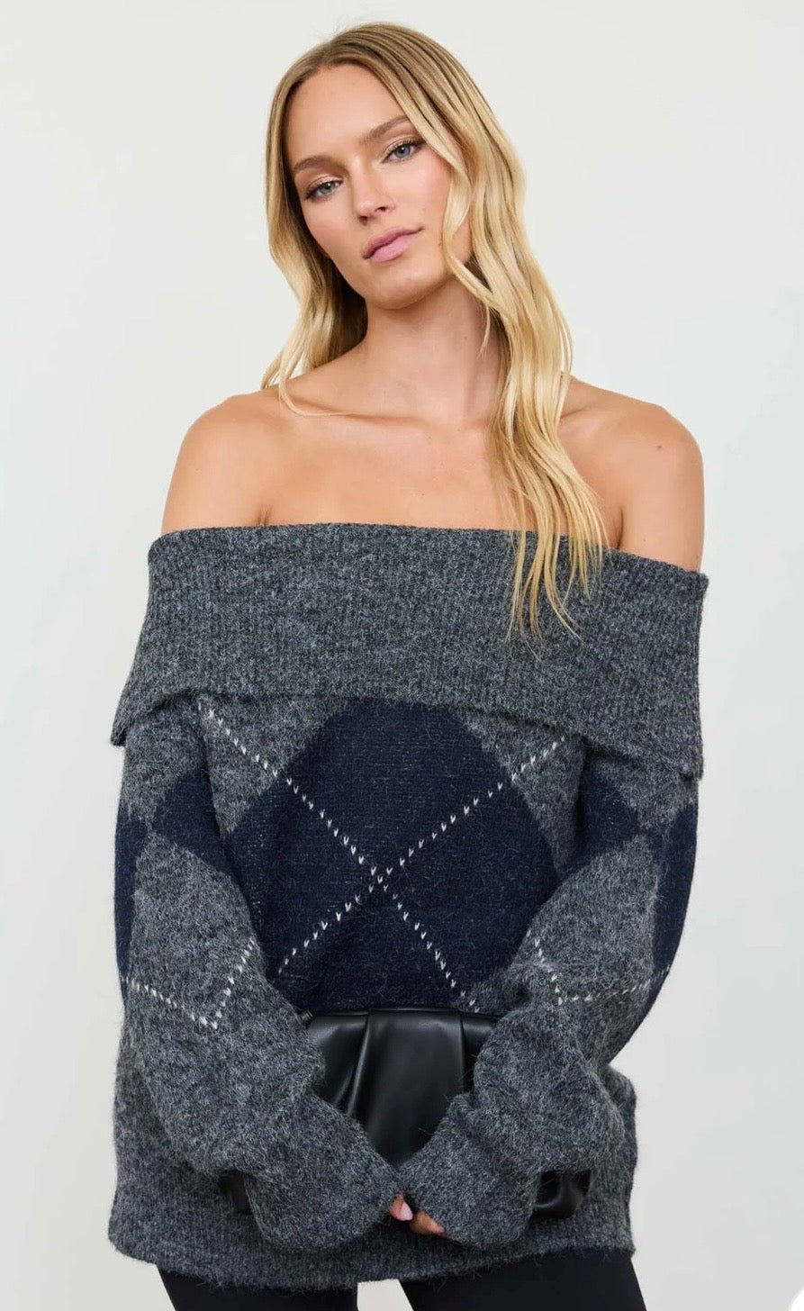 Off-the-shoulder sweater in charcoal gray with a navy argyle diamond pattern and long sleeves