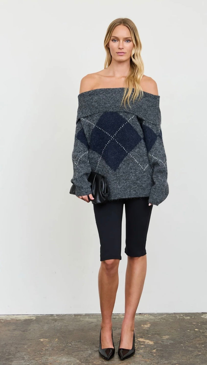 Off-the-shoulder charcoal gray sweater with navy argyle diamonds and a relaxed fit